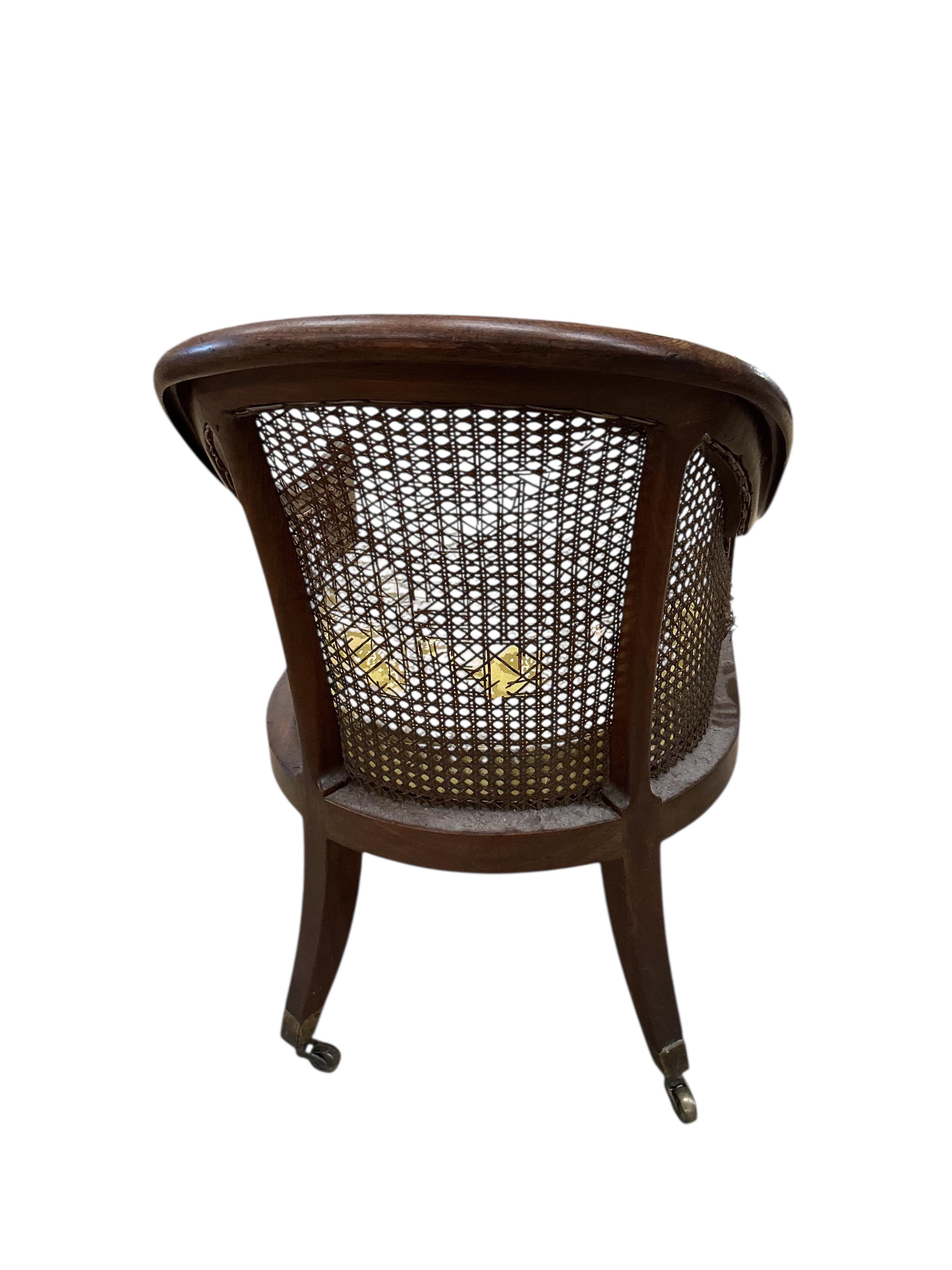 A Regency mahogany caned bergere armchair, (damaged cane) together with a Regency simulated rosewood and brass caned bergere armchair, larger width 49cm, depth 60cm, height 83cm